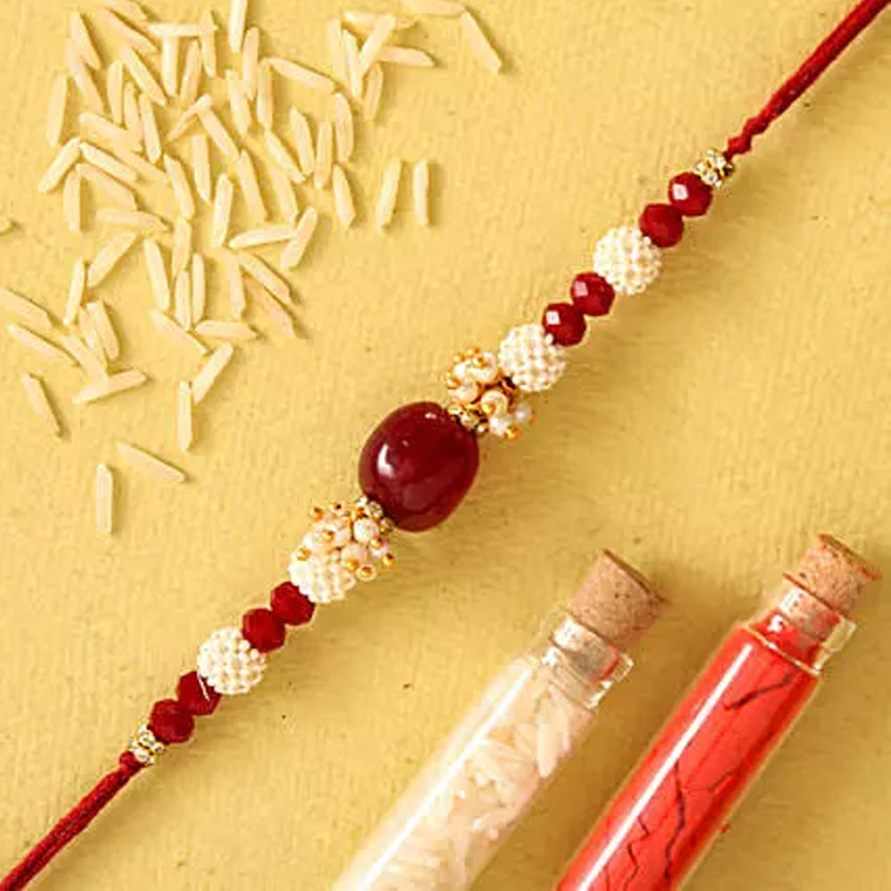 Rakhi - Red Beads Pearl Designer Rakhi And Healthy Almonds
